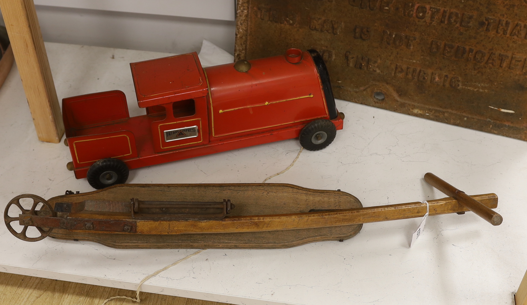 A Tri-Ang Express tinplate toy locomotive and an early 20th century beech folding scooter, the train 50cm in length